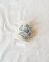 Ceramic mug with blue floral pattern on a white surface